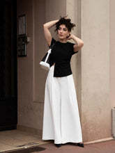 A woman wears a pair of pants